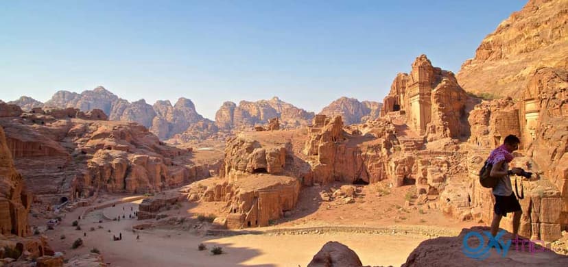 Visitors walking through The Siq canyon towards Petra lost city